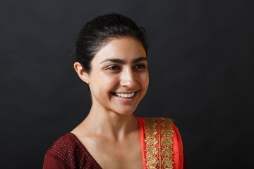Portrait of young adult smiling indian woman in sari.