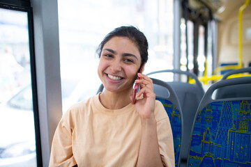 Indian Woman ride in public transport bus or tram with mobile smartphone