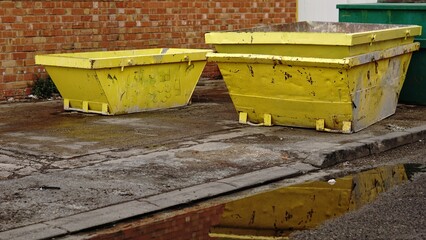 stacked yellow industrial debris containers