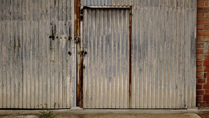 rusty and worn industrial metal door as a background