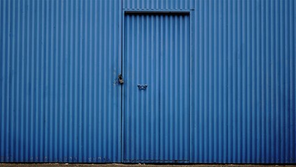 metal blue door from industrial building as background