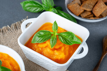 Bowl of delicious autumn pumpkin soup with rye croutons