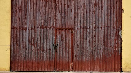 large metal worn and rusty factory entrance