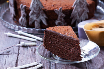 Chocolate honey cake in a Christmas decoration on a wooden background.