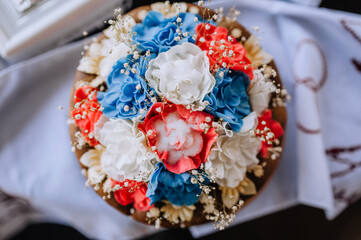 Beautiful round, decorated with flowers and salt, wedding Ukrainian loaf with a towel close-up. Food photography.