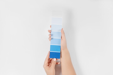 Hand holding Color samples palette design catalog.