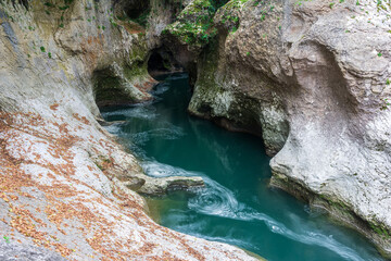 beautiful landscape with a mountain river among the stone rocks in the gorge, shot on long exposure