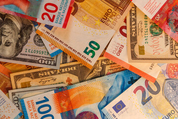 Fototapeta na wymiar Multicurrency background of US dollars, euros and Swiss francs