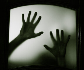 scary picture of hands behind glass, horror ghost woman behind door, Halloween  concept