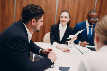 Fototapeta premium Businessman and businesswoman team at office meeting. Business people group conference discussion sit at table with boss man and woman