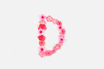 A letter D made from real fresh flowers. Creative floral font concept. Unique collection of letters and numbers for design. Spring, summer, autumn and valentines, creative idea,