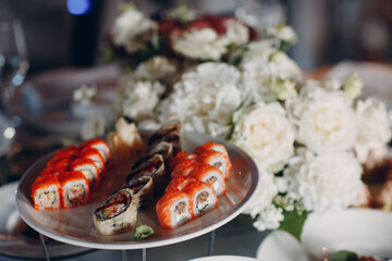 Japanese rolls and sushi on a plate in a restaurant catering party Concept.