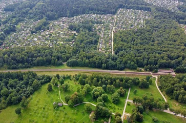 Foto op Canvas Aerial view of the green summer forest with trees © Payllik