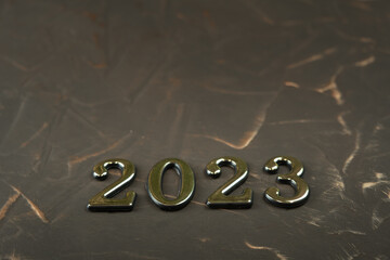 metal numbers 2023 symbolizing the advent of the new year and Christmas on a brutal forged...