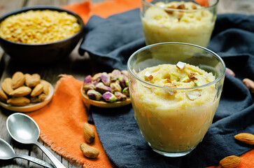 Naklejka na ściany i meble Lentils halwa. Indian sweets in a glass on a wood background