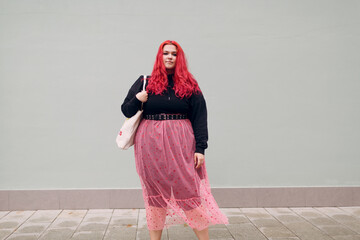 Plus size overweight fat body positive lgbtq woman with red hair and pink glasses.