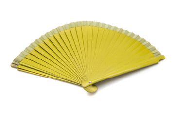 Mustard colored fan, isolated on white background. A fan is a fashion accessory designed so that with a rhythmic and variable movement of the wrist, air can be moved and cooling facilitated.