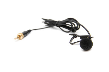 Lavalier microphone, isolated on white background. Selective focus. A lavalier microphone (also called a lavalier microphone, clip-on microphone, or personal microphone).