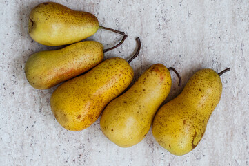 Five yellow pears, top view.