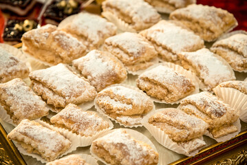 a lot of baked oriental desserts with powdered sugar for the whole frame
