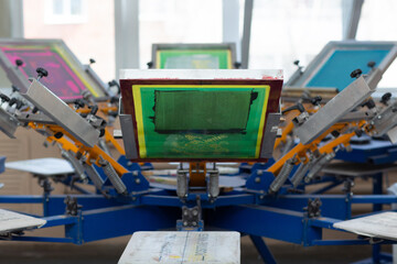 Carousel Frame, squeegee and plastisol color paint Serigraphy silk screen print process at clothes...