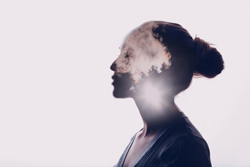 Psychology and woman mental health concept. Multiple exposure clouds and sun on female head silhouette. - obrazy, fototapety, plakaty