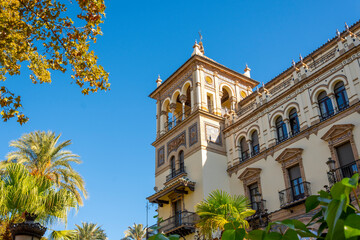 A historic building highlights Spanish architecture with Moorish influence in the Barrio Santa Cruz district of Seville, Spain. - obrazy, fototapety, plakaty