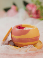 Soy candle in a concrete, plaster candlestick, decor interior. Home decoration with a burning scented candle. Gypsum, concrete products.