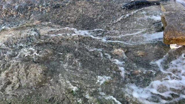 Dirty water flows from the pipe into the river. Sewerage, treatment facilities