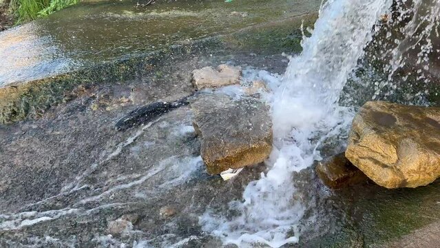 Dirty water flows from the pipe into the river. Sewerage, treatment facilities
