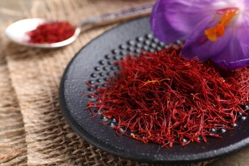 Dried saffron and crocus flowers on table, closeup