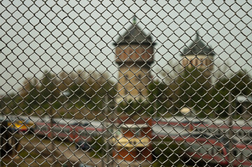 metal mesh, in the photo a mesh chain link against the background of city towers