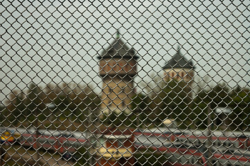 metal mesh, in the photo a mesh chain link against the background of city towers
