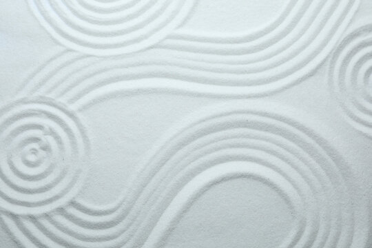 White sand with pattern as background, top view. Zen, meditation, harmony