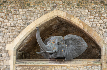 London, England, UK - July 6, 2022: Tower of London. Fake gray elephant head looks out of stables...