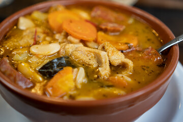 a close up of a pot with tripe and some vegetables.