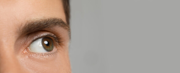 Closeup view of man with beautiful eyes on light grey background, space for text. Banner design