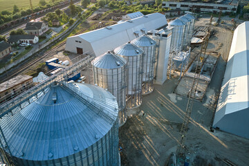 Aerial view of industrial ventilated silos for long term storage of grain and oilseed. Metal...