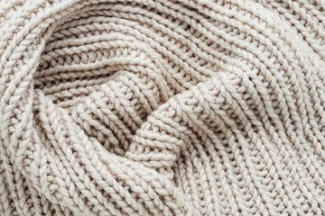 Knitting. Vertical striped beige knit fabric texture, knitted pattern background. Top view