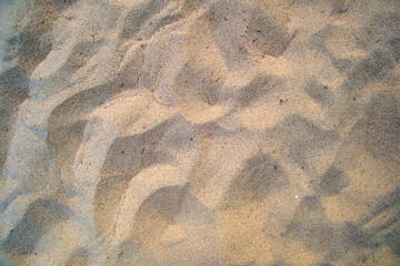 Flat view of clean yellow sand surface covering seaside beach. Sandy texture