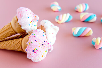 Dried ice cream and marshmallows on pink background