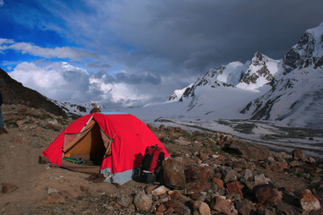 A tent at the base camp of Darkoot pass, near Lake Karambar in Pakistan. Captured around sunset and in a cloudy weather with beautiful sky.  © Haani Pasha