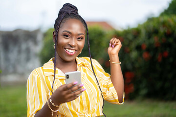 image of excited african lady with smartphone
