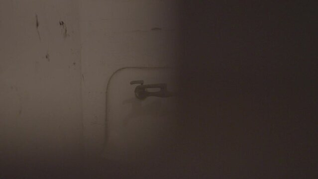 Dirty shower inside a jail house during a tour
