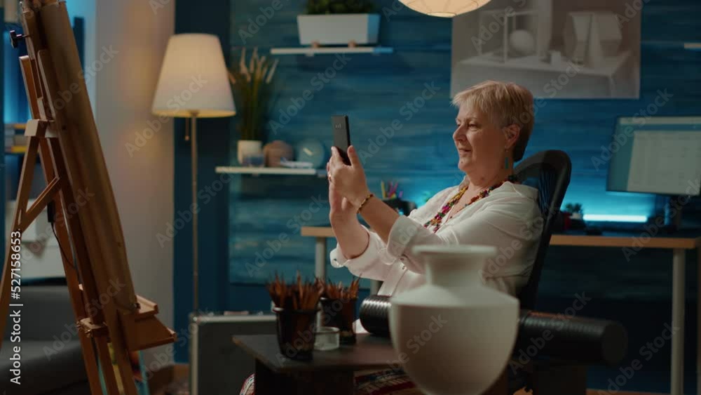 Aufkleber retired person using smartphone to take picture of vase drawing on canvas, saving artwork sketch in 