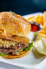 Cheeseburger topped with Fried Eggplant and a side of French Fries