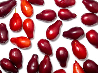 Dogwood berries on a white background. Lots of red berries. Useful fruit. Healthy food. Tart berry.