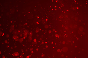 Red glitter vintage lights background.  red bokeh shiny on dark background.