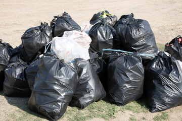 Many trash bags full of garbage outdoors. Environmental Pollution concept