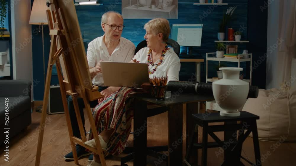Aufkleber team of senior artists looking at artistic inspiration on laptop, drawing masterpiece sketch with co